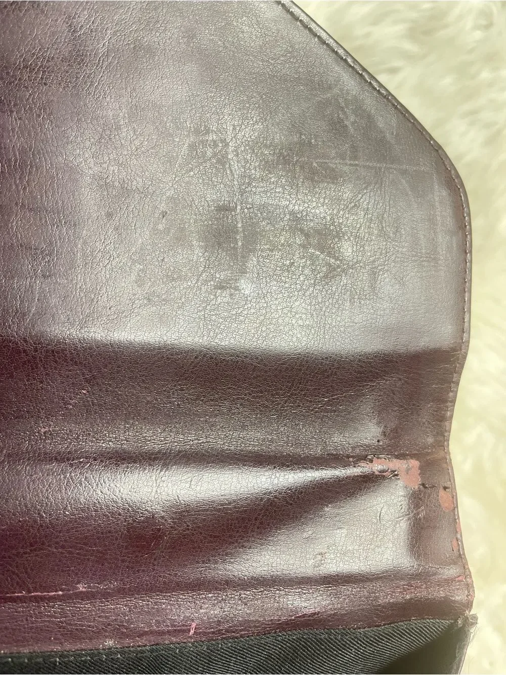 M.C textured leather patchwork like stitched accent burgundy leather bag .